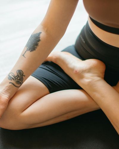 Close-up on a person's feet during a stretching exercise, showing focus.